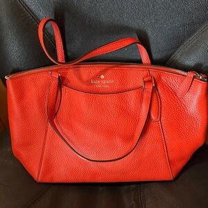 Kate Spade New York medium shoulder bag in bright orange pebbled leather.
